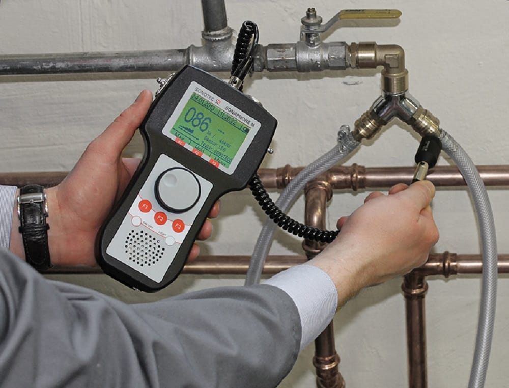 Plumber testing pipes with electronic leak detection equipment in Wellington